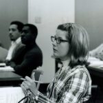 Student asking question in classroom.