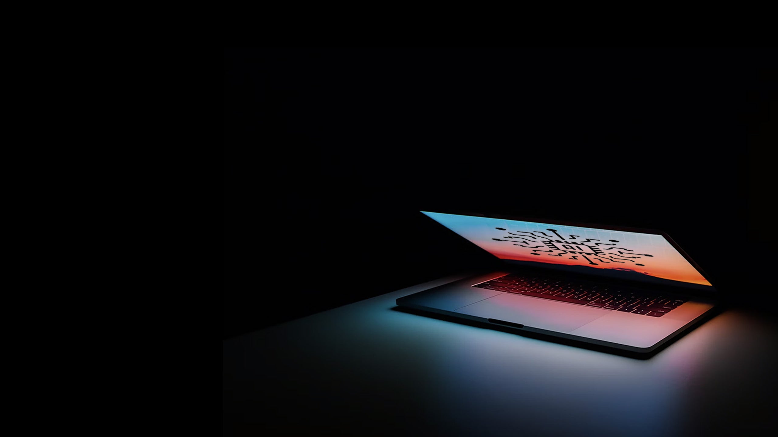 Image of laptop open on a desk.