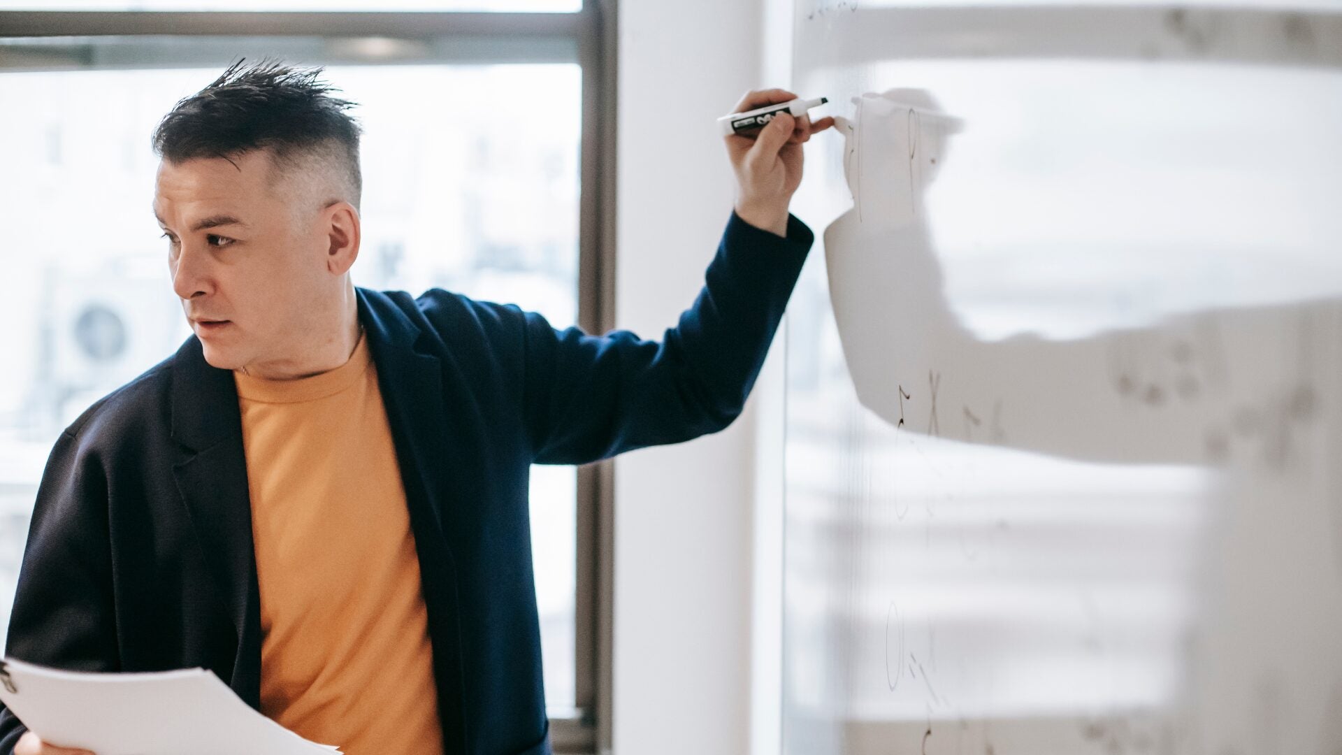 Man working at white board