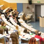 Students attend a lecture in one of the classroom halls at the GGU Parkmerced campus.