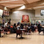 Students eat in the bottom floor dining area in the Cesar Chavez Student Center at GGU's Parkmerced Campus.