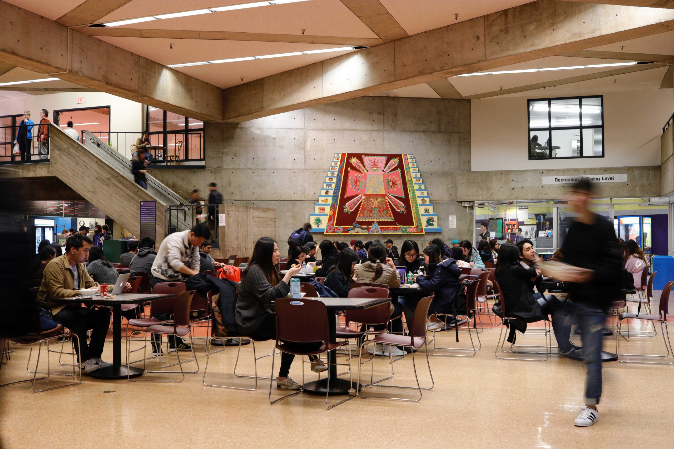 Students eat in the bottom floor dining area in the Cesar Chavez Student Center at GGU's Parkmerced Campus.